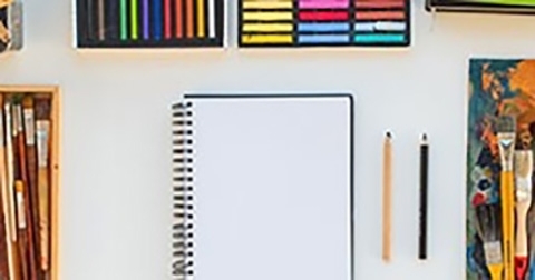 Stock image of a sketchbook and pencils