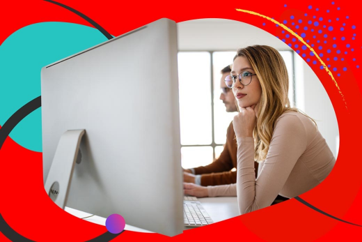 Woman in front of computer screen wearing glasses.