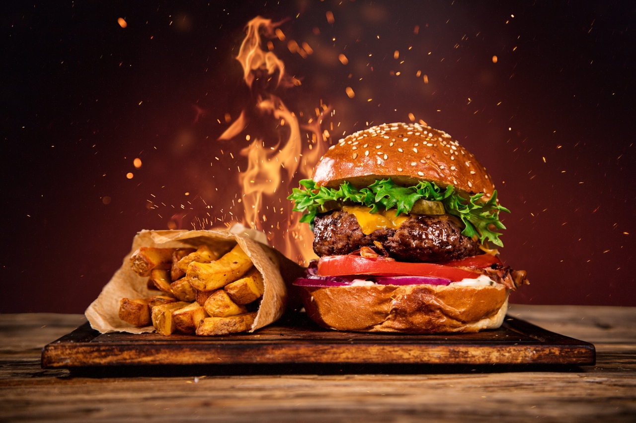 a styre reference of a burger with a fiery background